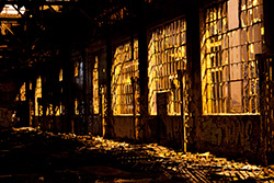 light through broken windows into abandoned building at night