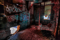 HDR image of abandoned factory interior with graffiti on brick walls