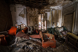 abandoned house interior with broken wall and dirty objects