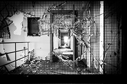 impact on broken window in derelict building, black and white photo