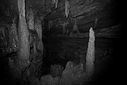 cave with stalactites and stalagmites in black and white picture
