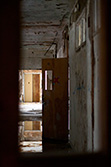 abandoned school corridor with opened door and water on floor