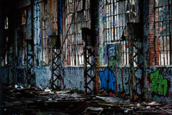 derelict building interior with crumbling wall and broken windows