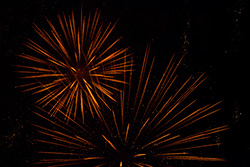 orange fireworks explosions with sparkles