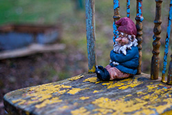 garden gnome seating on old chair close-up