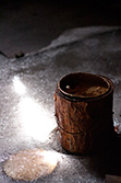 pain pot with rust on ice in sunlight