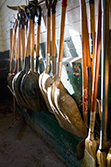 shovels hang on wall in farm