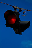 red road light on cable with blue sky