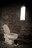 old toilet in room with window