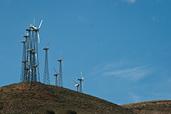 windmills on hills on blue sky