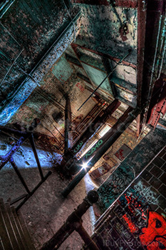 Abandoned factory art in HDR photo with stairs and pipes