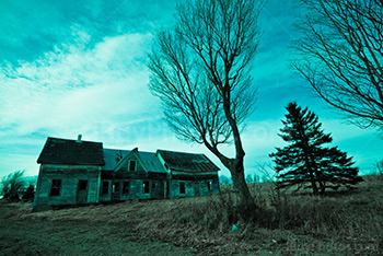 Abandoned house in countryside, blue tint photo