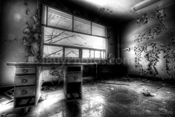 Creepy office with desk and drawers in abandoned building, black n white HDR