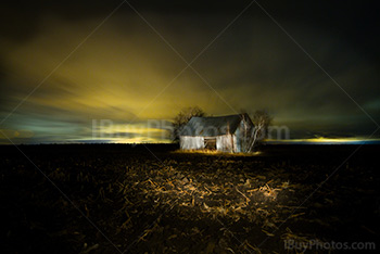 Light painting sur vielle grange dans un champ de boue