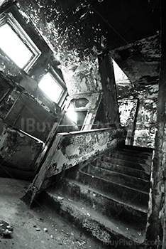 Old creepy stairs in abandoned asylum with peeling walls