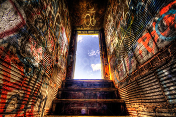 Stairs and doorway HDR with graffiti on wall in building