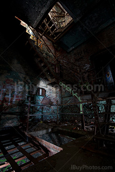 Rusty stairs in dilapidated factory with light painting
