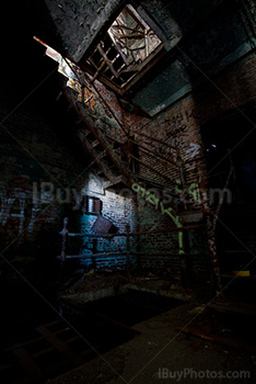 Rusty stairs and graffiti in derelict factory building with light painting