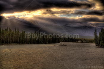 Sunbeams at sunset on river in HDR photo, Athabasca, Alberta