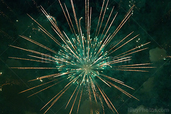 Green fireworks sparkle and puffs of smoke