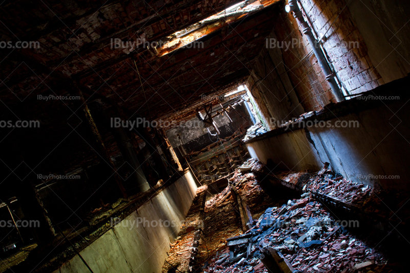 Intérieur de bâtiment en briques abandonné avec débris sur le sol