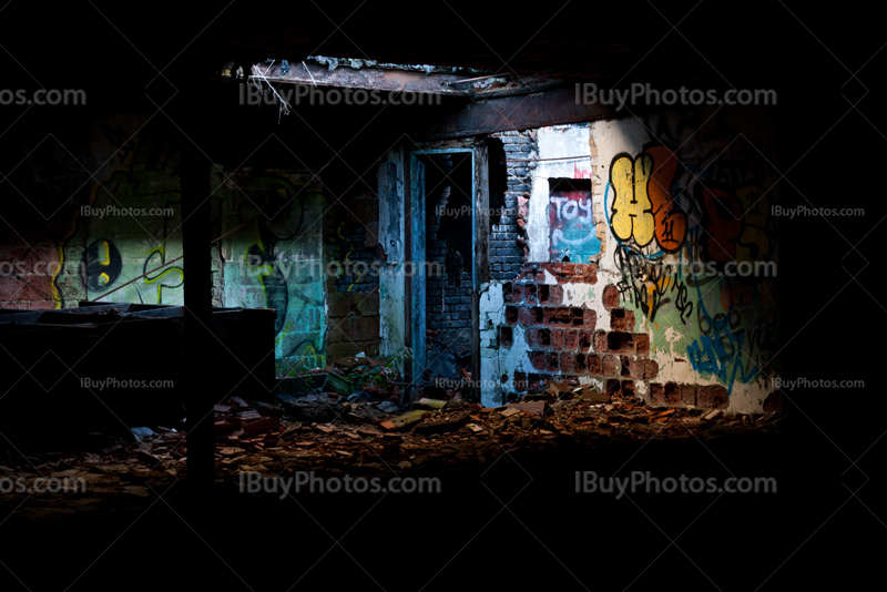 Abandoned factory with light on bricks walls with graffiti