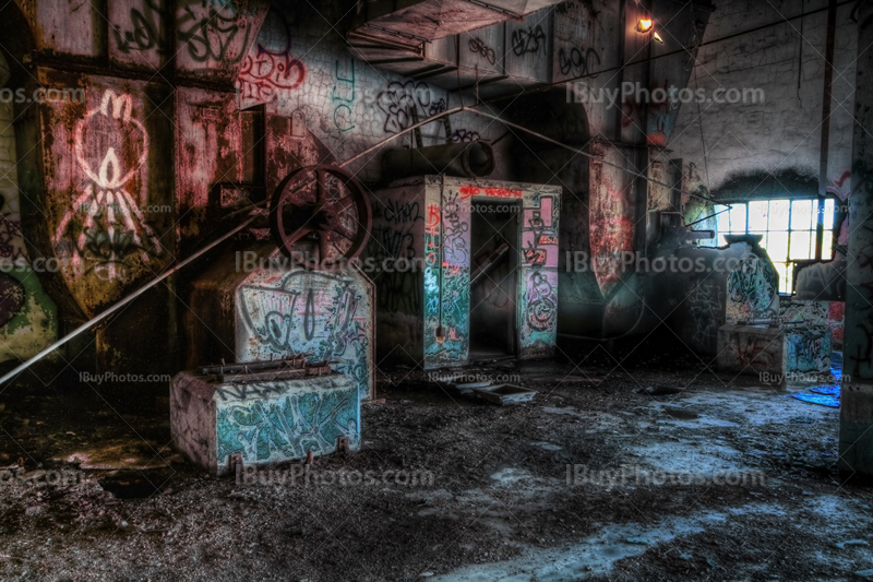 Derelict factory room with fragments and graffiti in HDR image