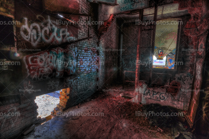 HDR image of abandoned factory interior with graffiti on brick walls