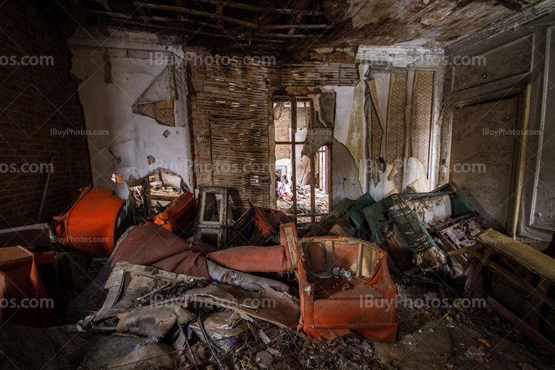 Abandoned house interior with broken wall and dirty objects