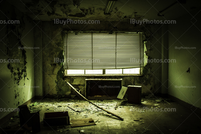 Creepy office with destroyed furniture and venitian blinds