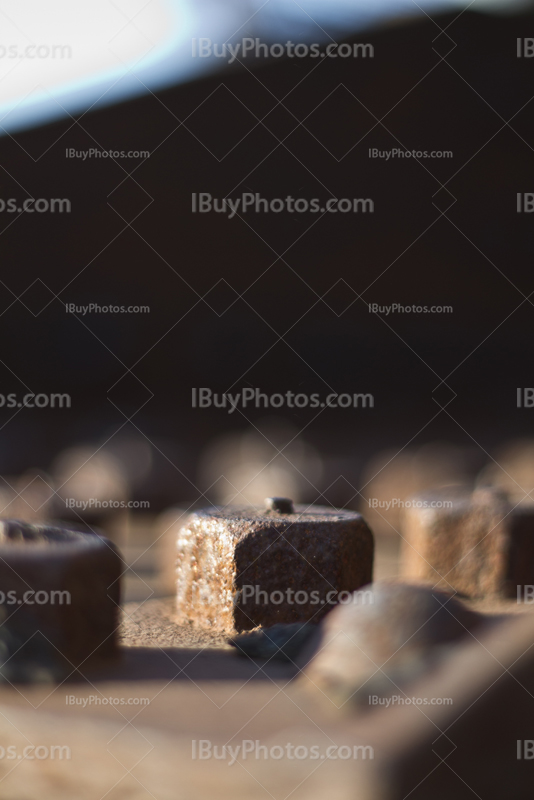 Rusty metal beam with bolts