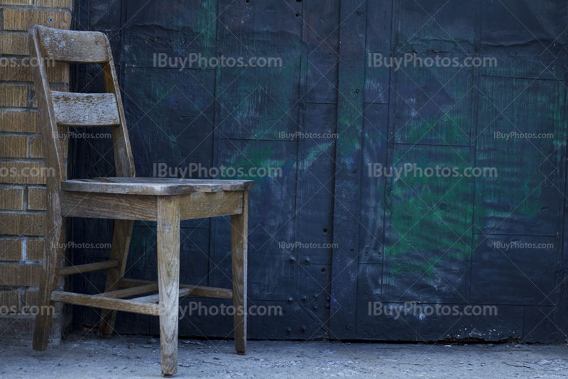 Chair in front of door with graffiti