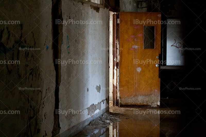 Abandoned school hallway with water on floor and reflection