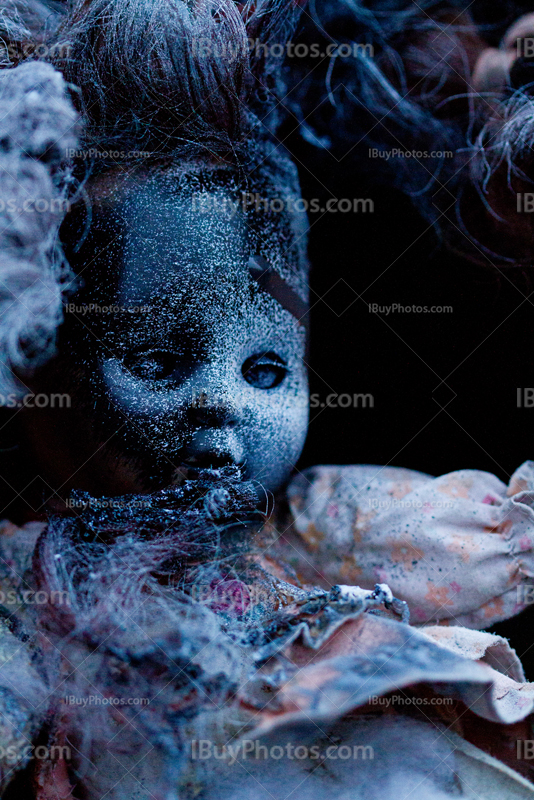 Old creepy doll with dress and paint srapy on face