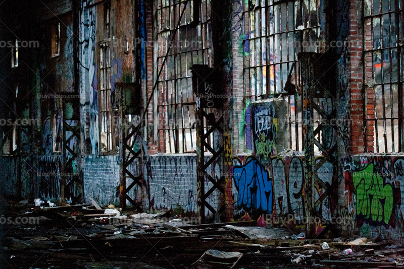 Derelict building interior with crumbling wall and broken windows