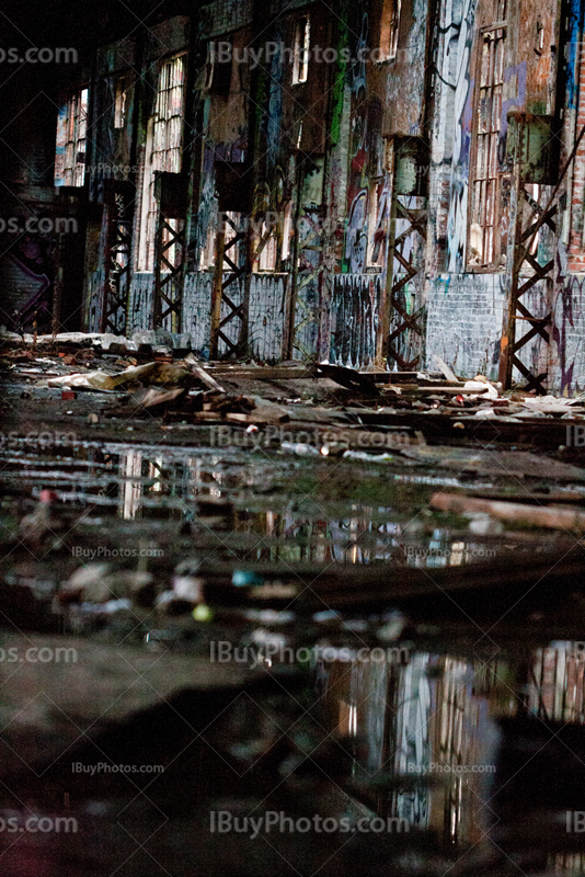 Water reflection in puddles in dilapidated building interior