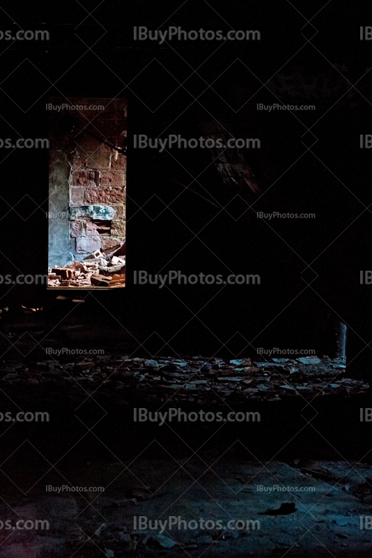 Doorway light in dark room in abandoned house