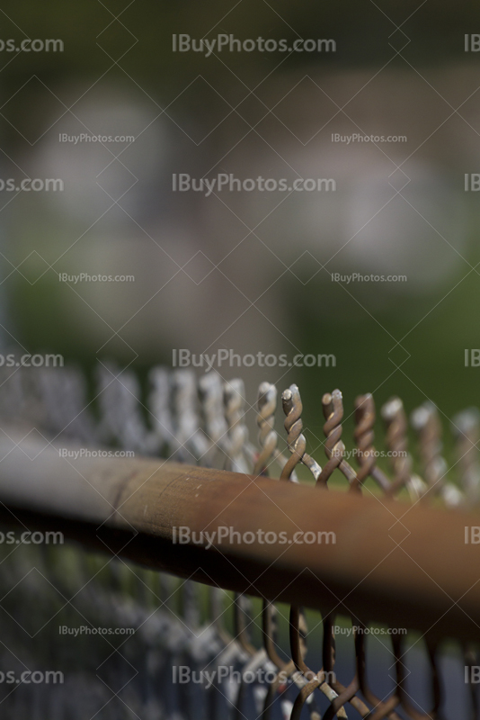 Rusty chain link fence top perspective