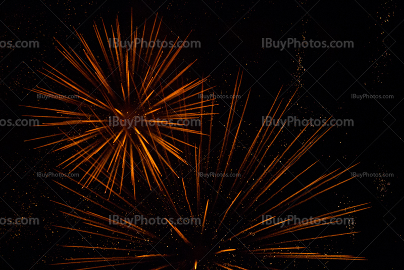 Orange fireworks explosions with sparkles
