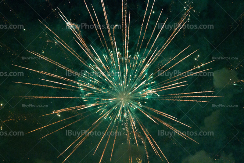 Green fireworks sparkle and puffs of smoke