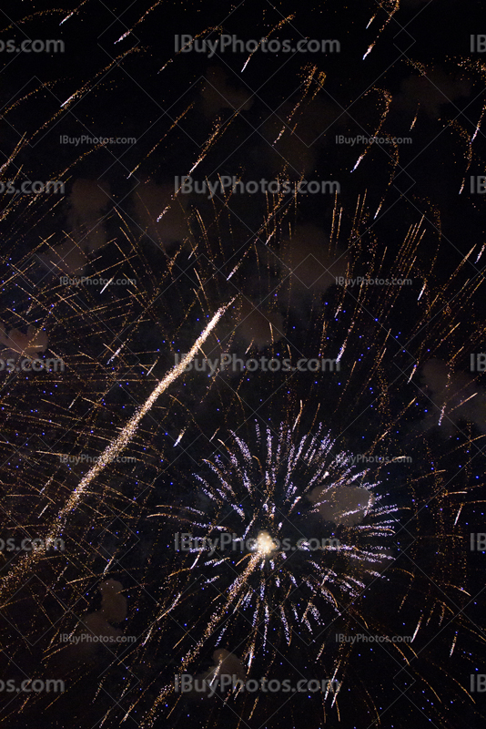 Bright bursts of fireworks with rocket trails