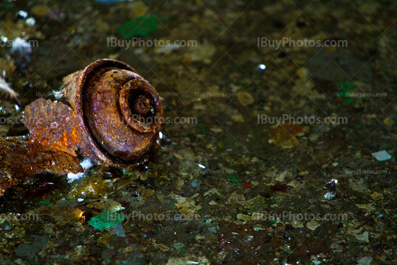 Rusty graffiti spray can on floor