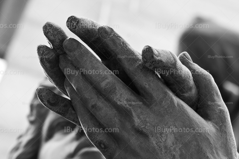 Holding hands on statue in black and white picture