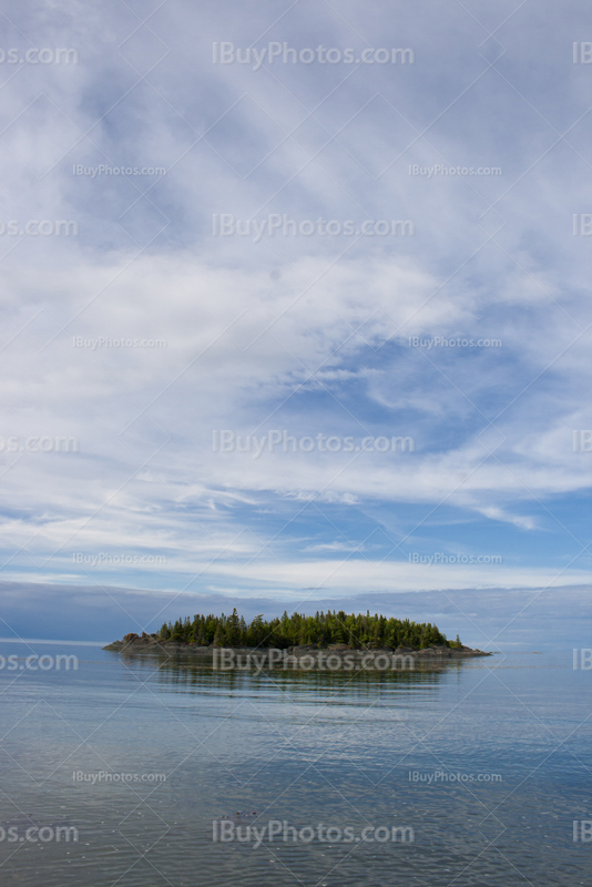 Small island in flat water of a river