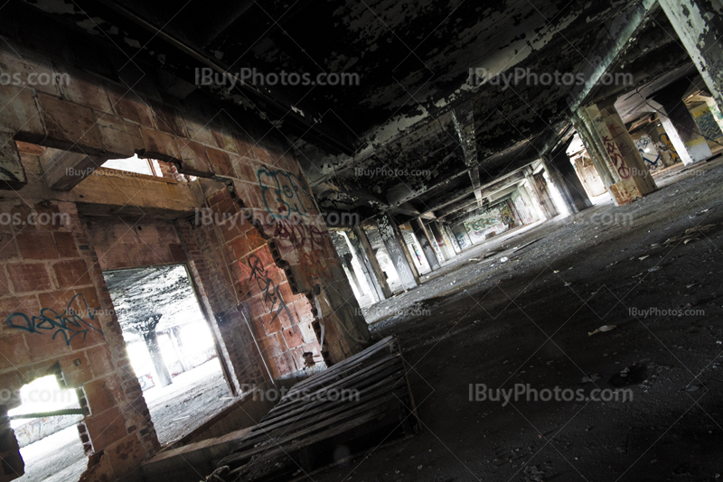 Abandoned parking perspective with damaged bricks walls