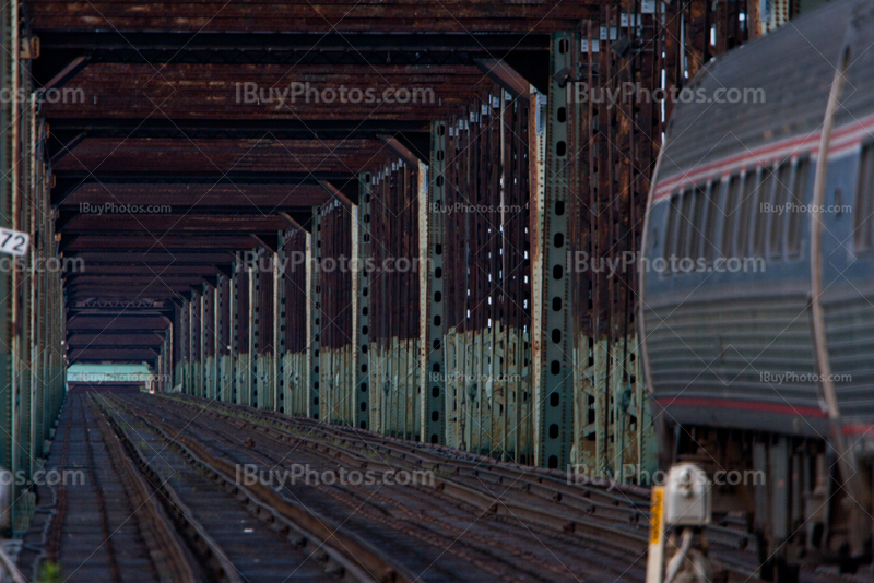 Train and wagons in steel railway bridge, vanishing point