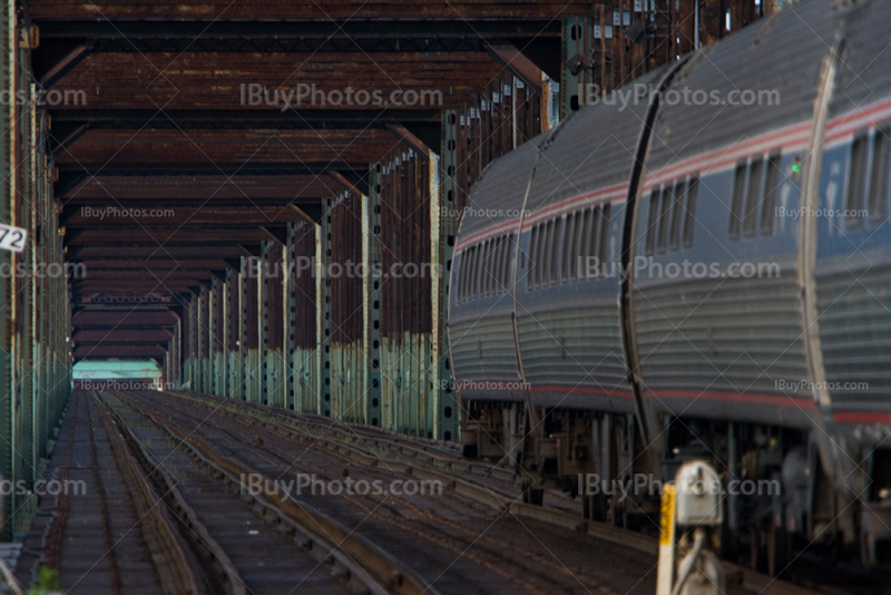 Train in steel railway bridge with vanishing point