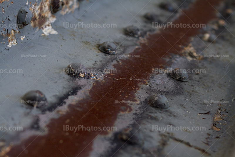 Metal beam with rusty bolts