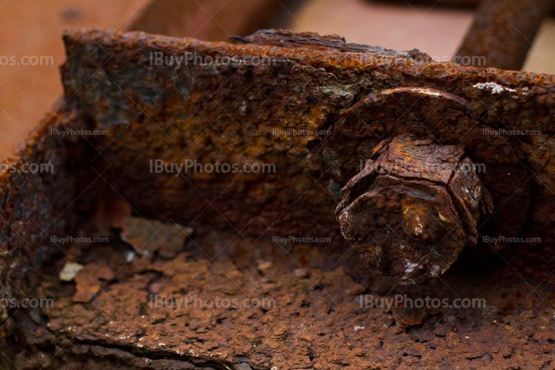 Old rusty bolt on metal plate