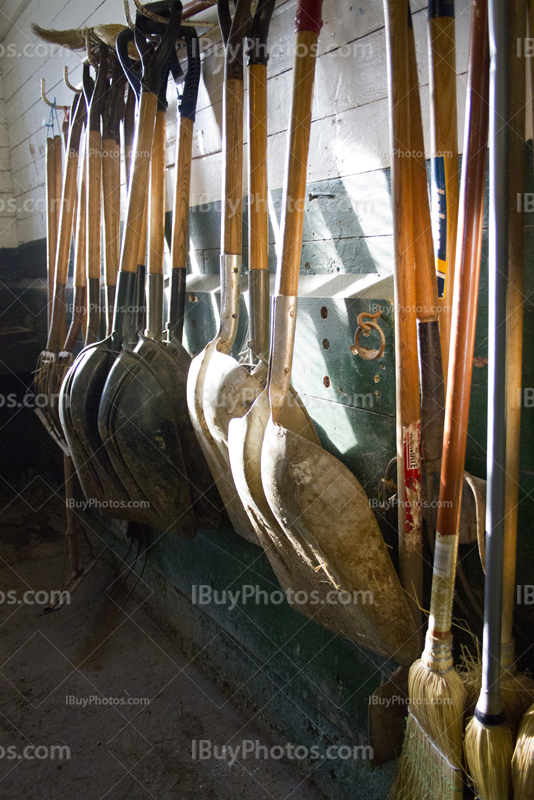 Shovels hang on wall in farm